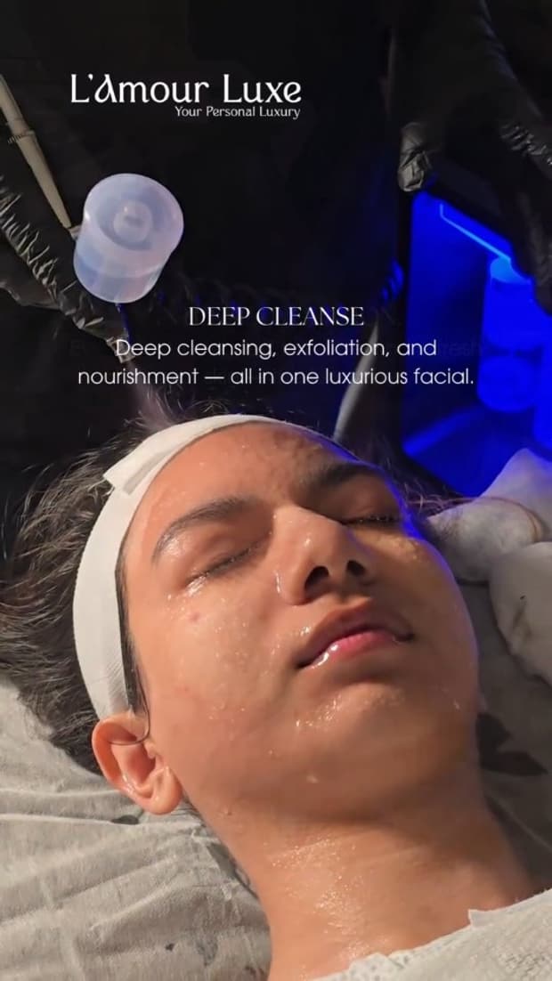 A deep-cleanse facial in progress under blue treatment light, the forehead wrapped in a white band.